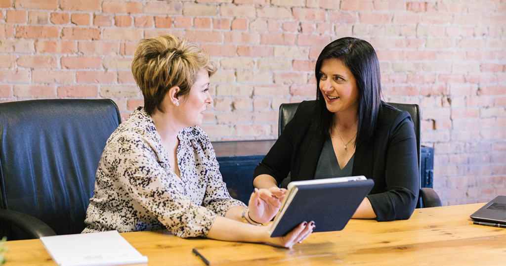 2 women talking about work to check in and lead a conversation in collaboration