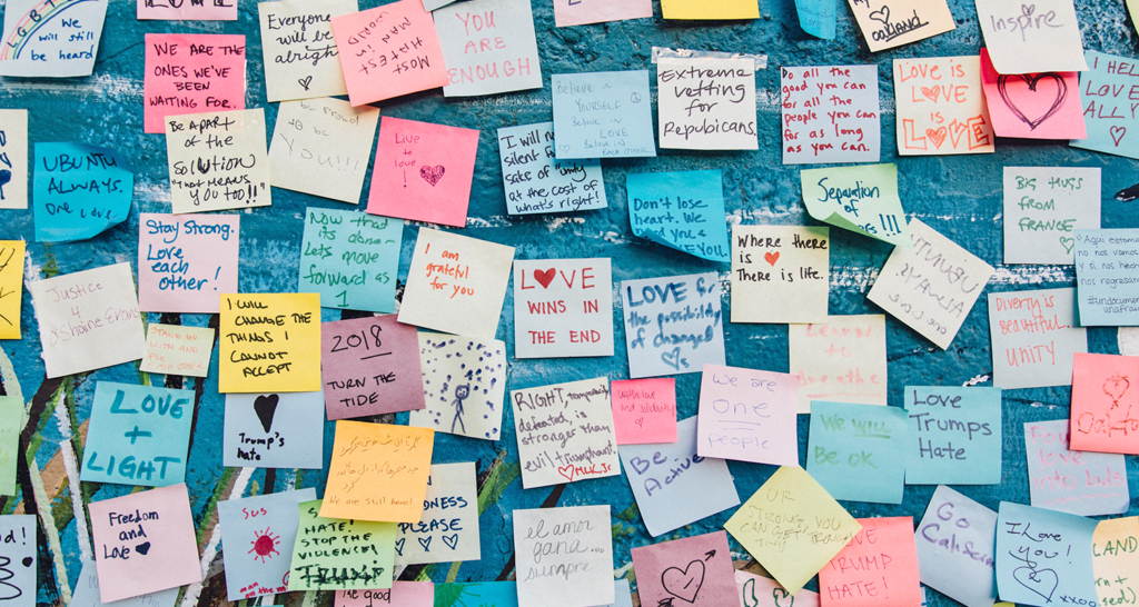 A blue wall of sticky notes with message of gratitude written on them