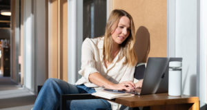 a women sitting outside on a Virtual Team Day call