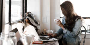 Remote worker at home work station with cluttered desk. Blog about workplace health.