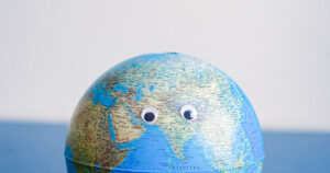 a globe with googly eyes on it
