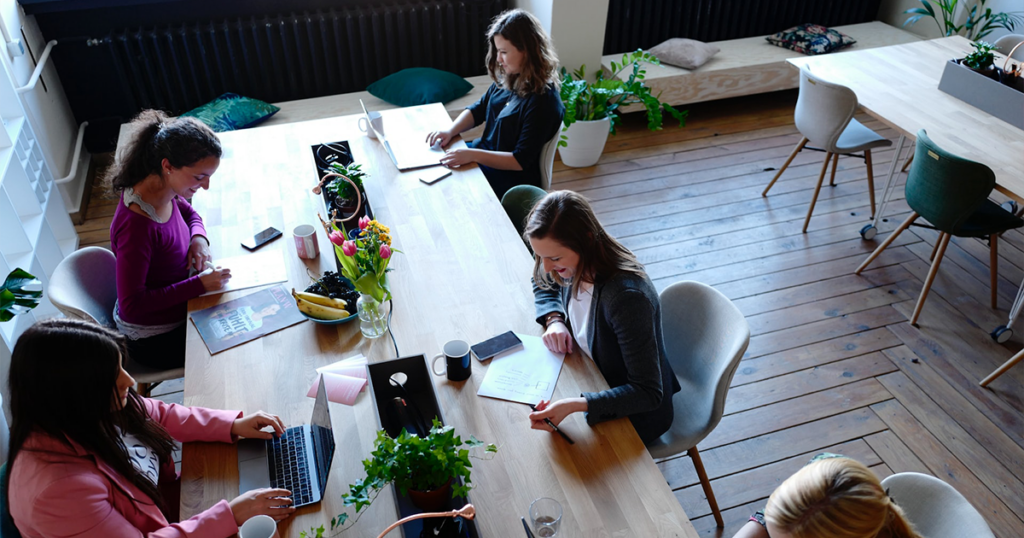 Happy team working at a large table together