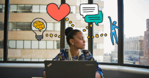 A women sitting infront of a laptop looking to the right. She has illustrated images of a heart, conversation bubble, human body, and a light bulb with a brain in it hovering over her head like she is thinking about which area of well-being she should focus on