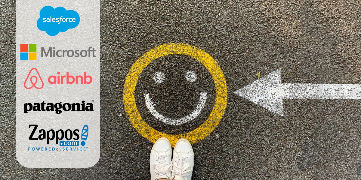 top down view of a smiley face painted on pavement. A painted arrow point at it from the right. On the left a side panel of companies that value employee wellbeing