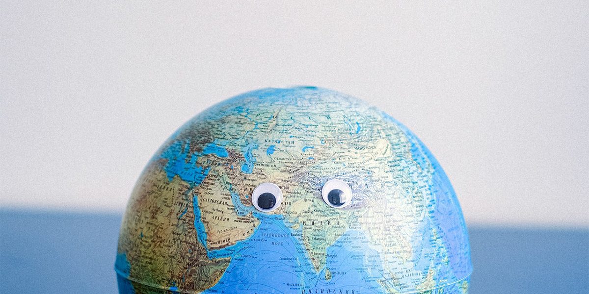 a globe with googly eyes on it