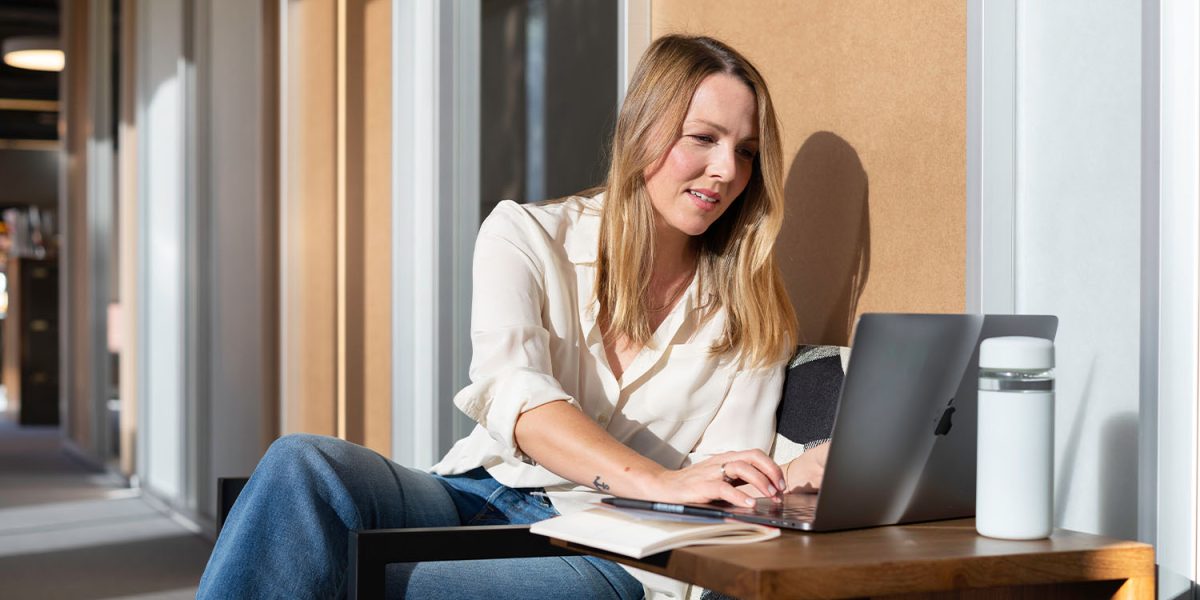 a women sitting outside on a Virtual Team Day call