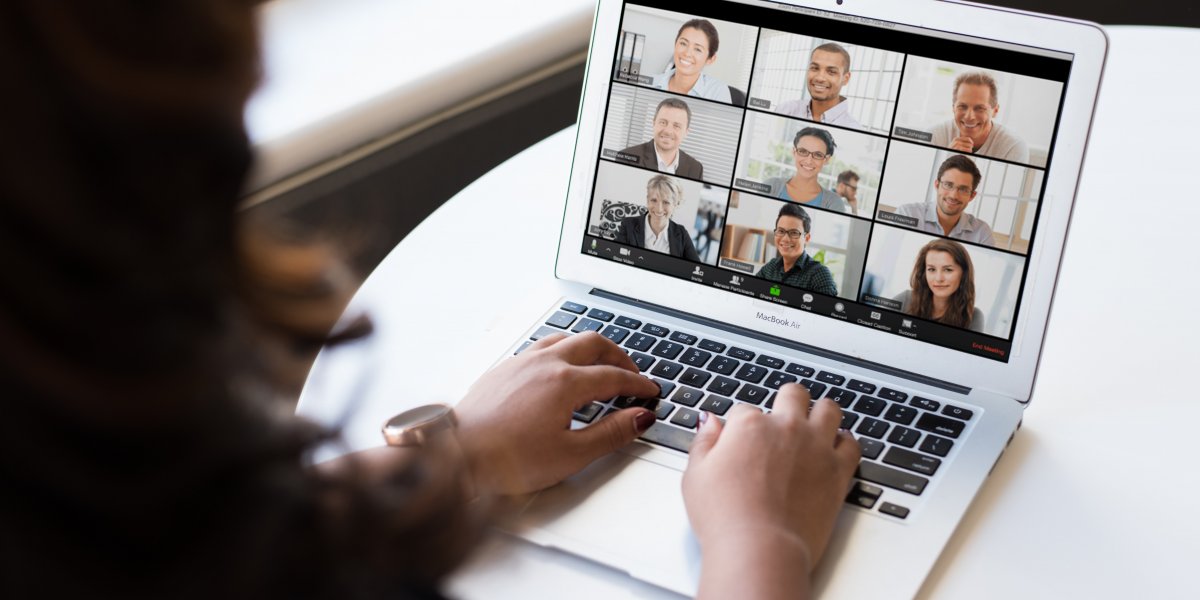 a computer that has 9 people on the screen having a virtual meeting